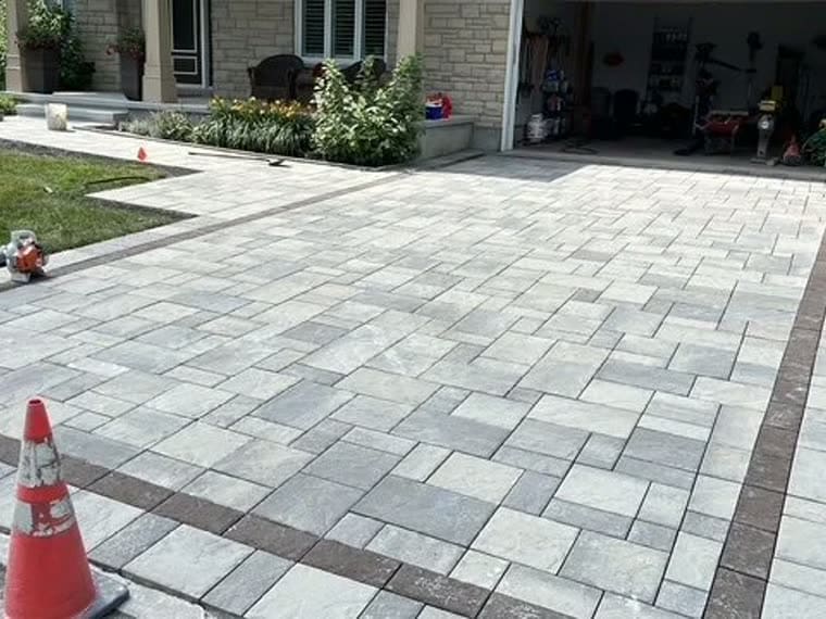 Extended interlock driveway adding extra parking beside a home