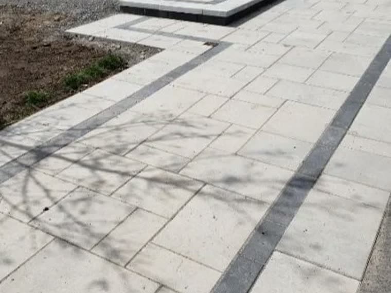 Wide interlock walkway with banded border, lifted and relaid on a fresh base