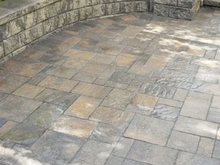 Curved segmental retaining wall around a raised interlock patio