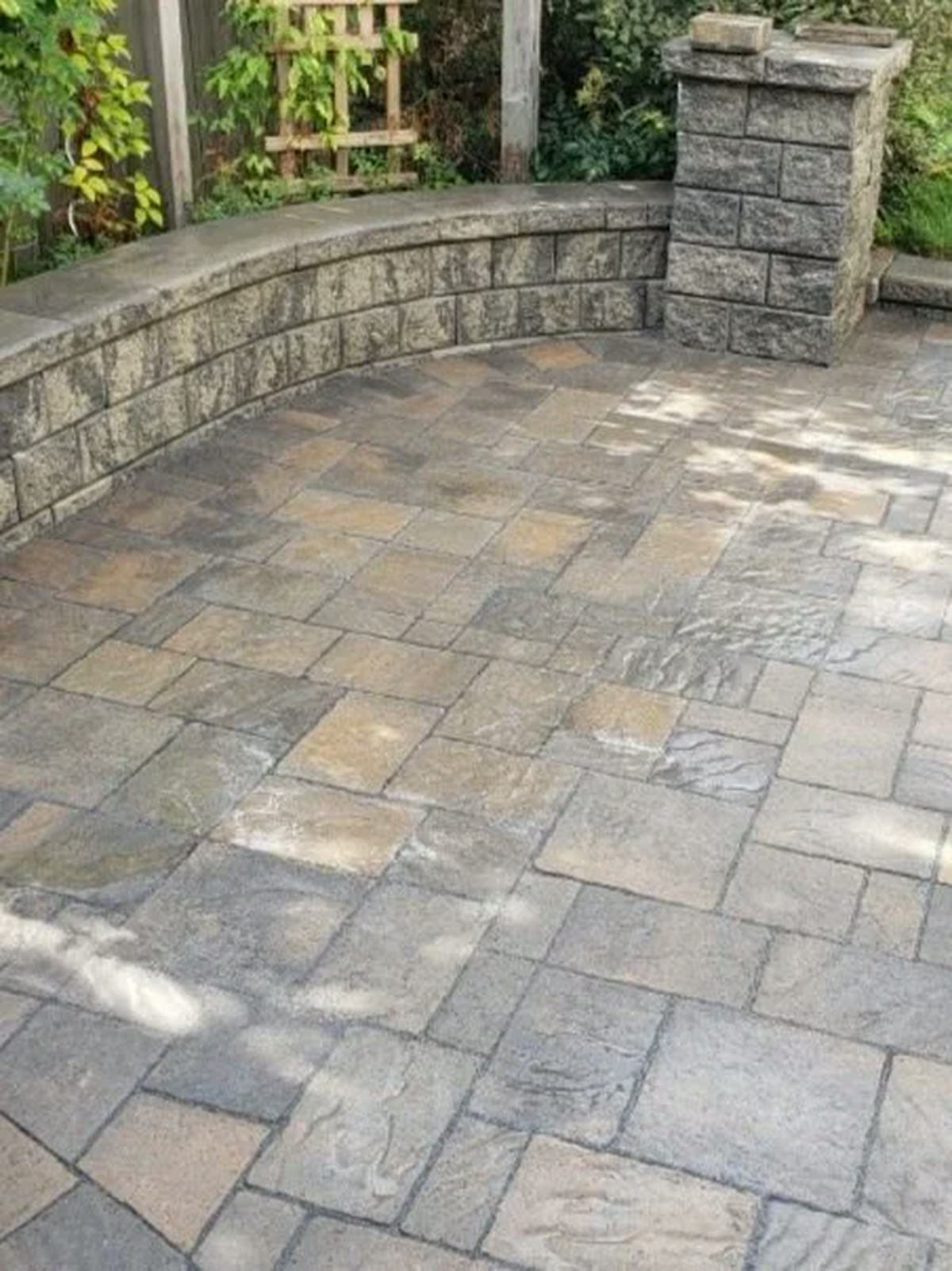 Interlock patio with a curved retaining seat wall